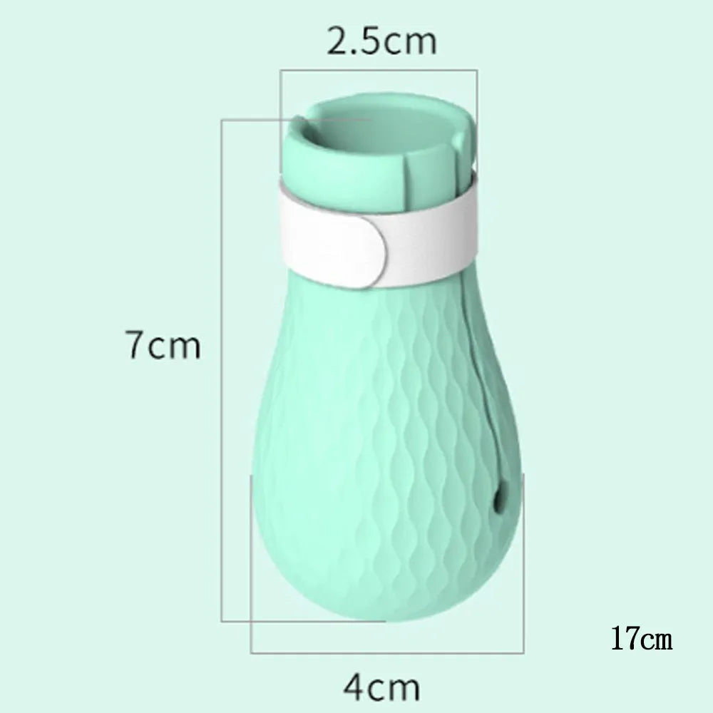 Set of four green silicone cat anti-scratch foot covers or gloves for pet handling.
