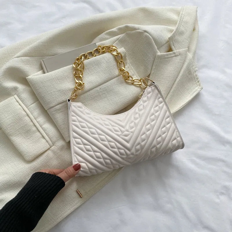 Brown pleated PU leather baguette bag with a gold-tone chain shoulder strap and a soft top handle.