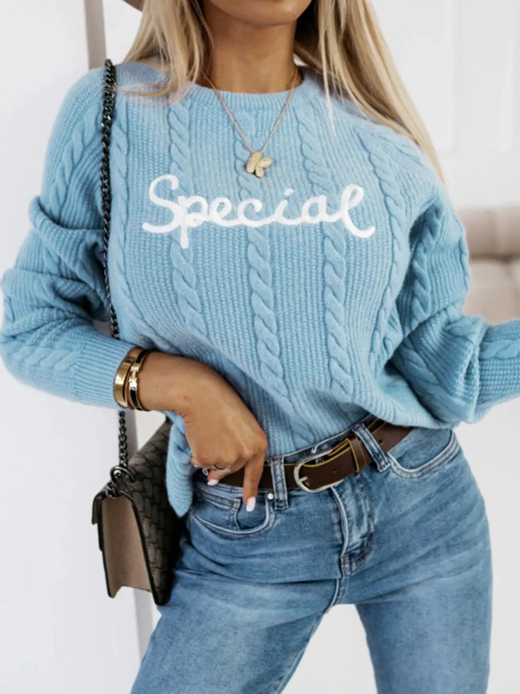 Blue crew neck pullover jumper with embroidered letter and number detailing on the front.