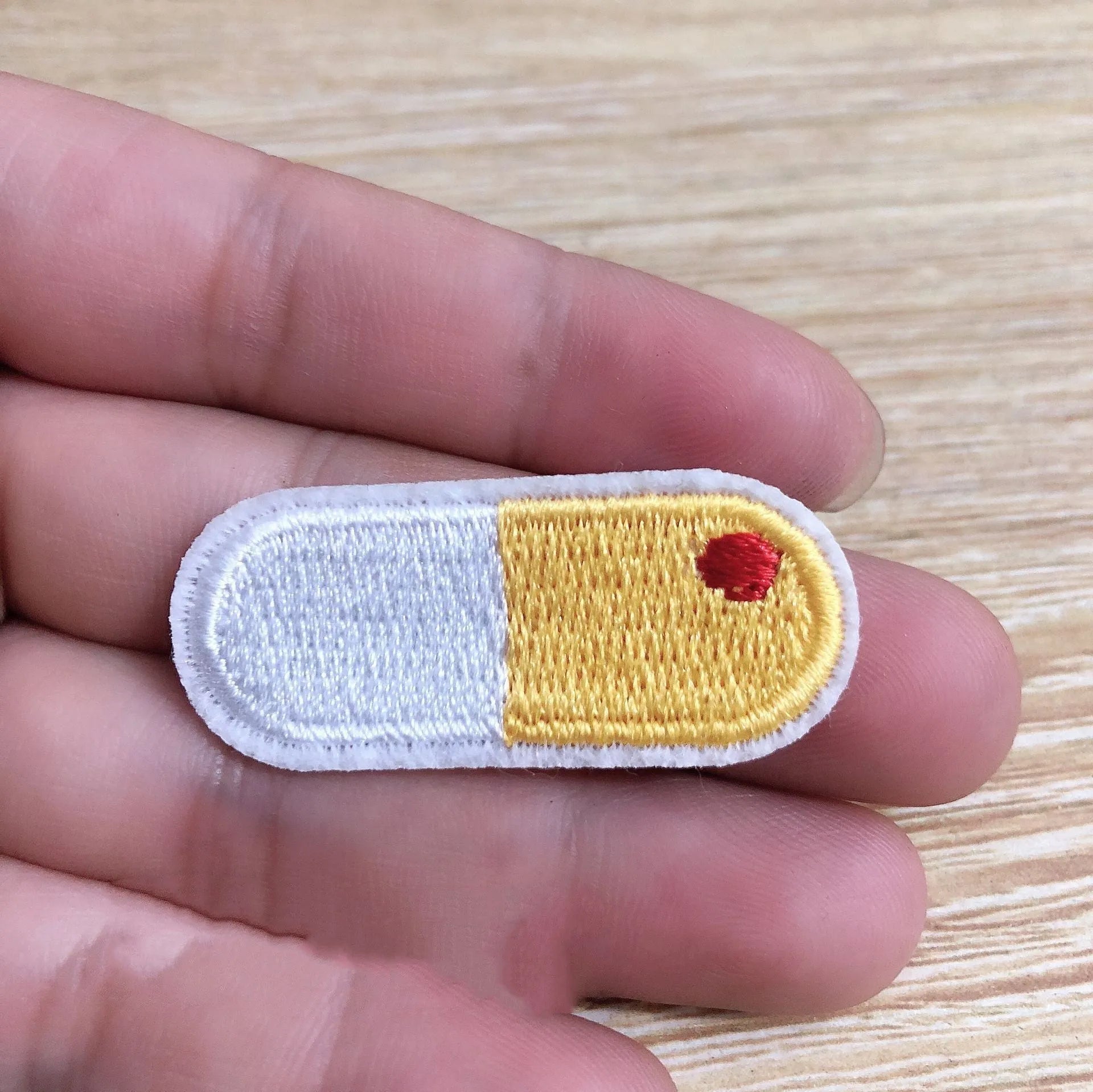 Ten computer-embroidered patch badges with adhesive backing for clothing decoration.
