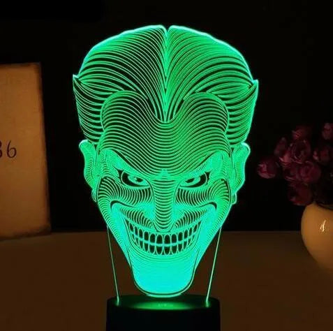 A 3D acrylic LED lamp displaying a gradient of colours, sitting on a square base with a USB cable.
