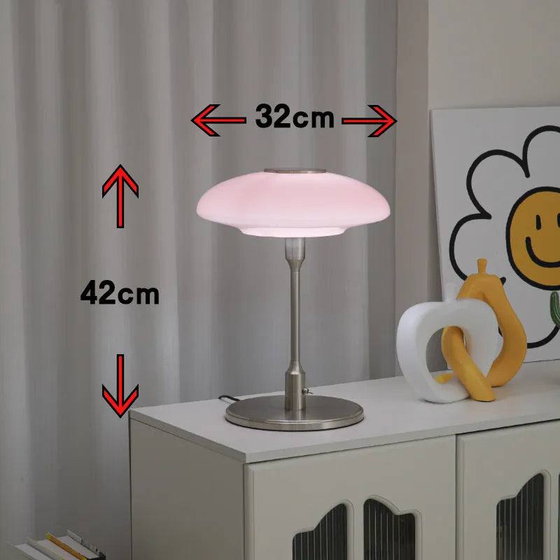 Korean style golden orange atmosphere light with metal base on a bedside table.
