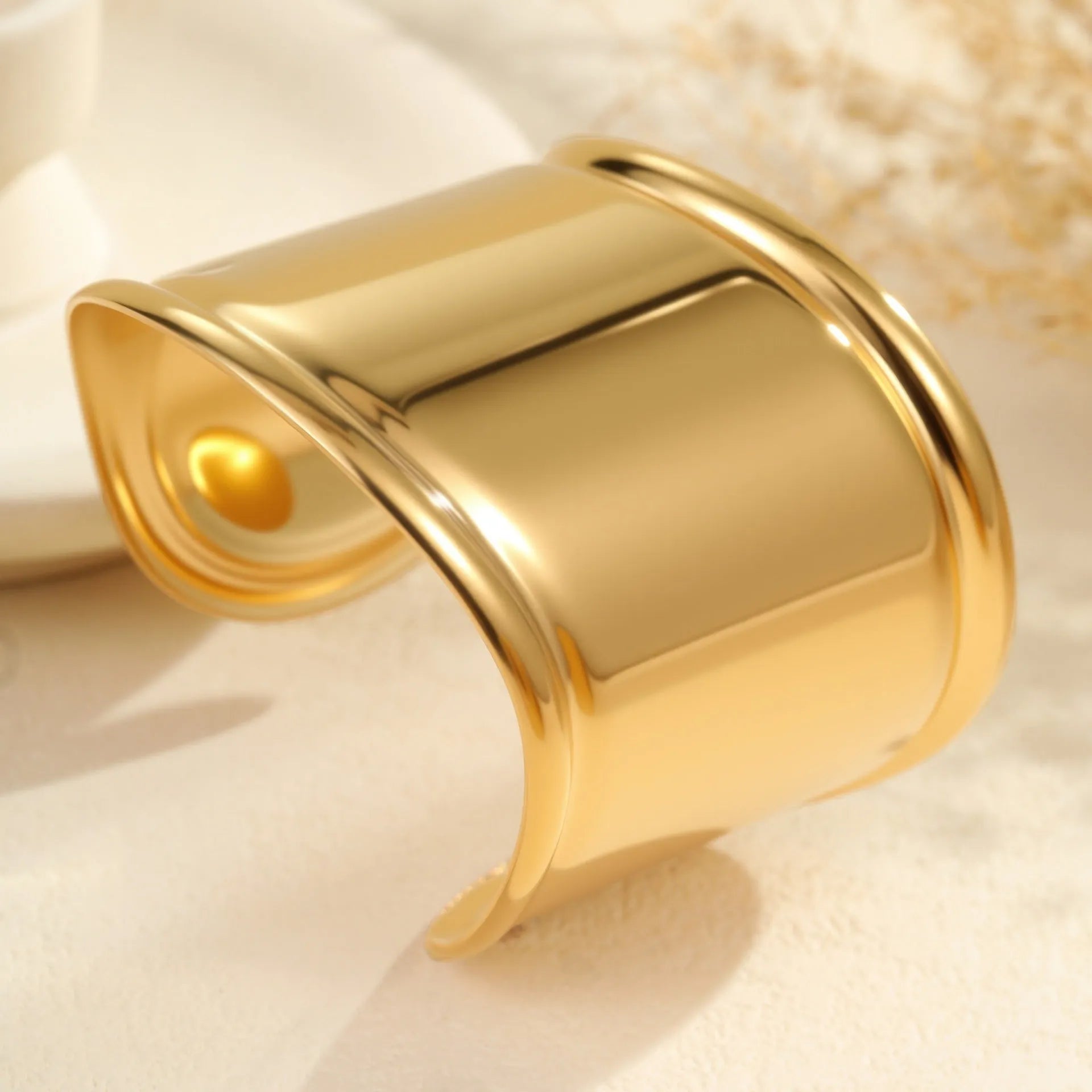 Women's stainless steel bracelet with 18K gold plating featuring wave geometric design