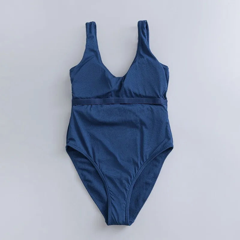 Navy blue women's one-piece swimsuit with slimming triangle design and chest pads