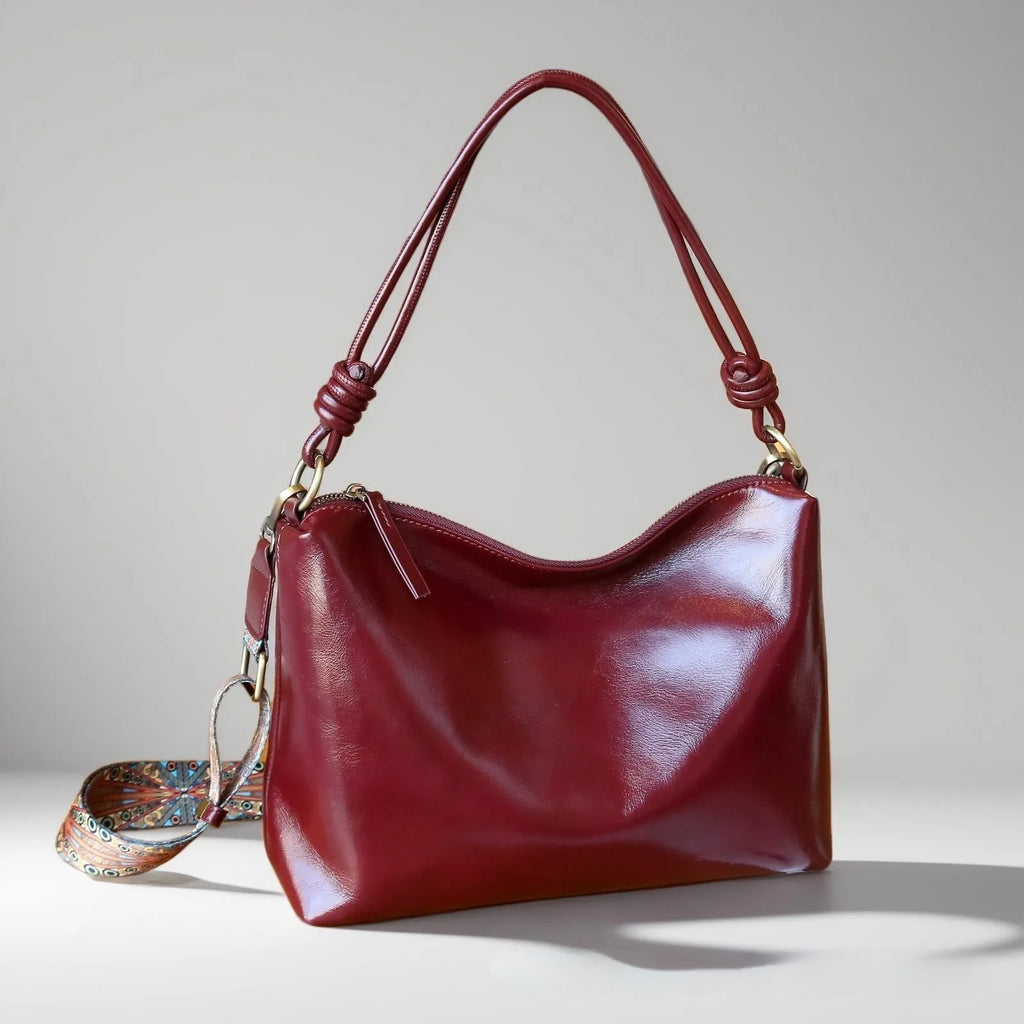 Genuine leather creative large capacity hand and shoulder commuter bag in caramel colour with pillow shape and patchwork details