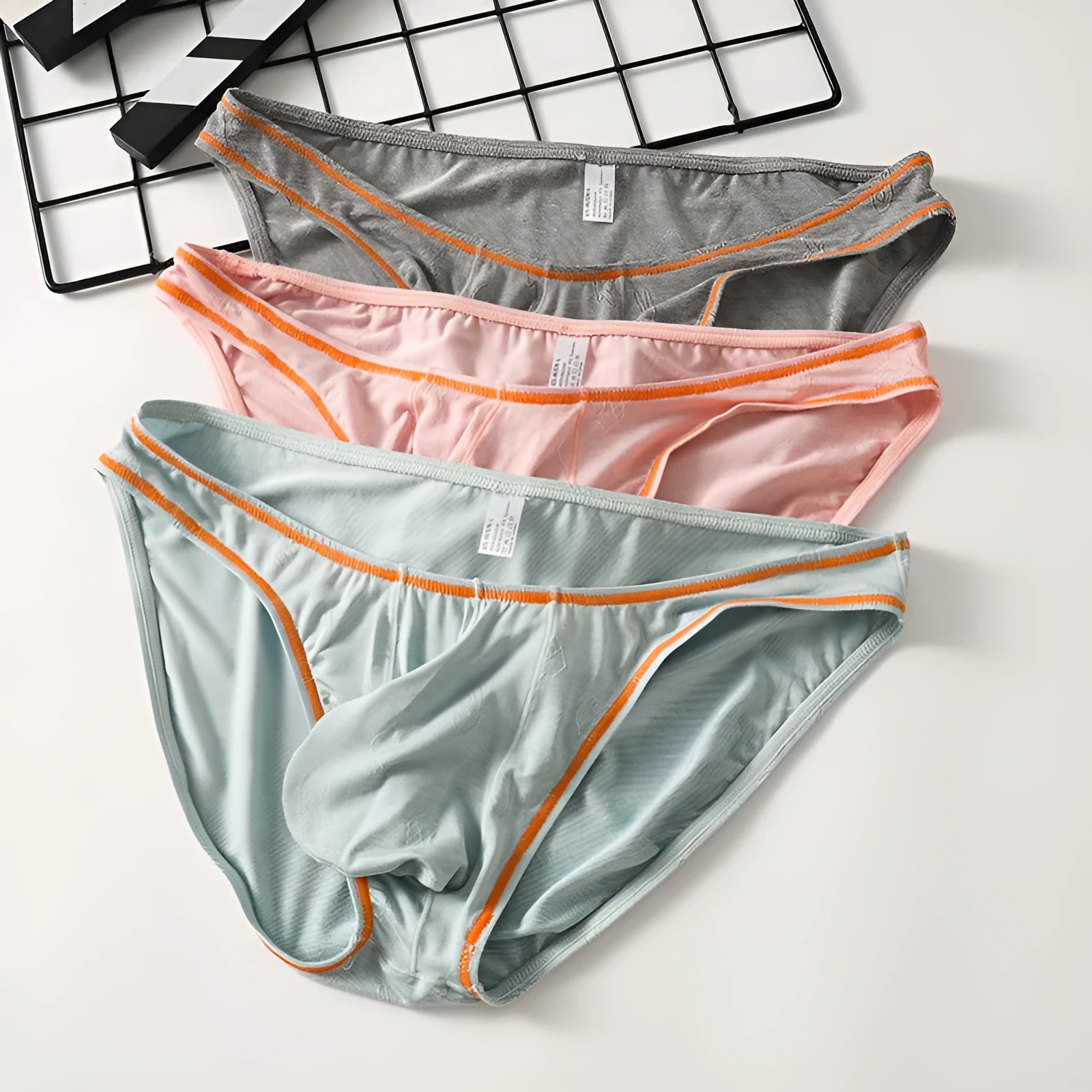 Men's hip-lift underwear in modal ice silk knit showing colour options and Asian sizing
