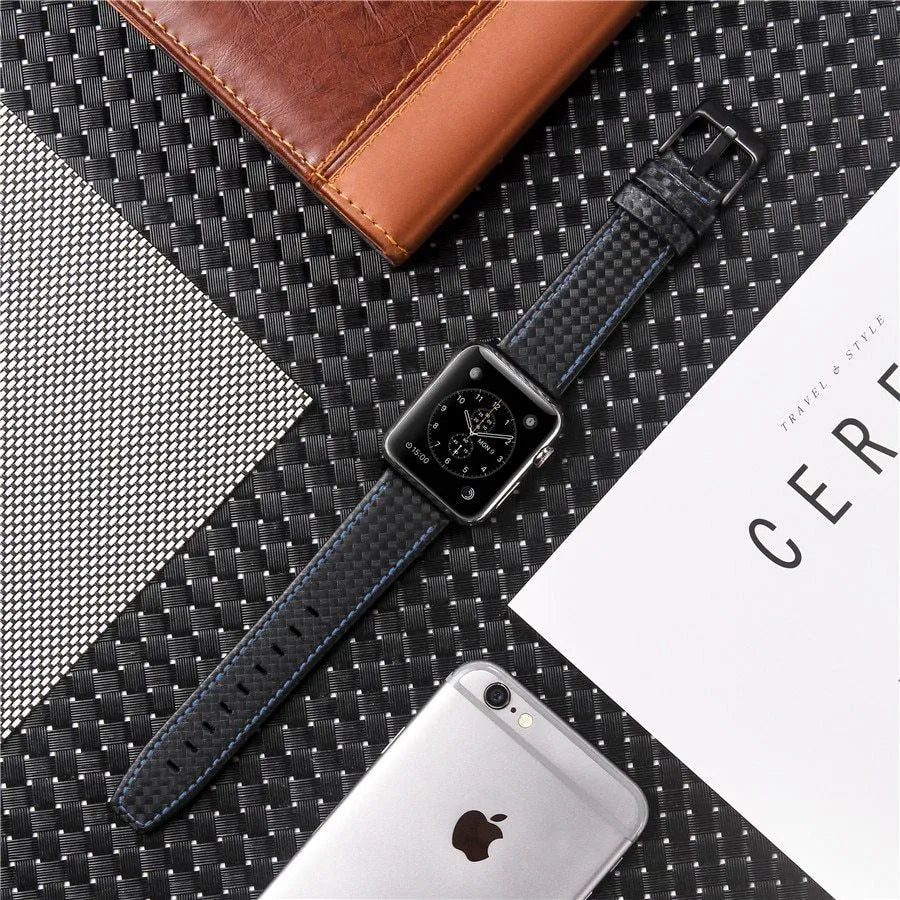 Apple Watch with black leather strap, carbon fibre details, and PC hard shell case with carbon fibre pattern.