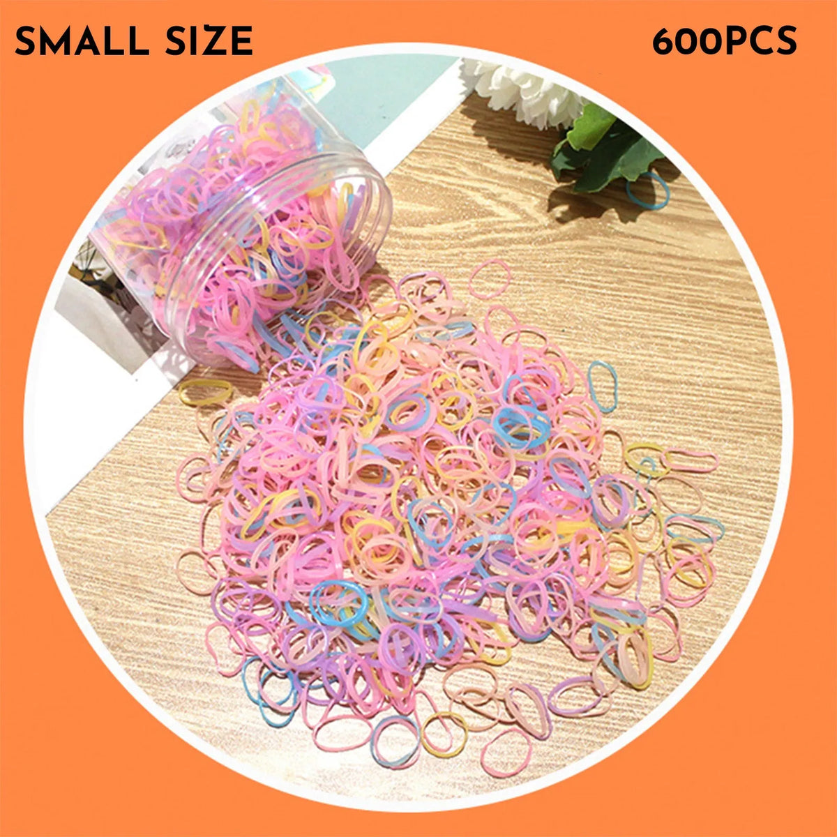 Assortment of colourful small TPU baby hair ties in a reusable plastic container.