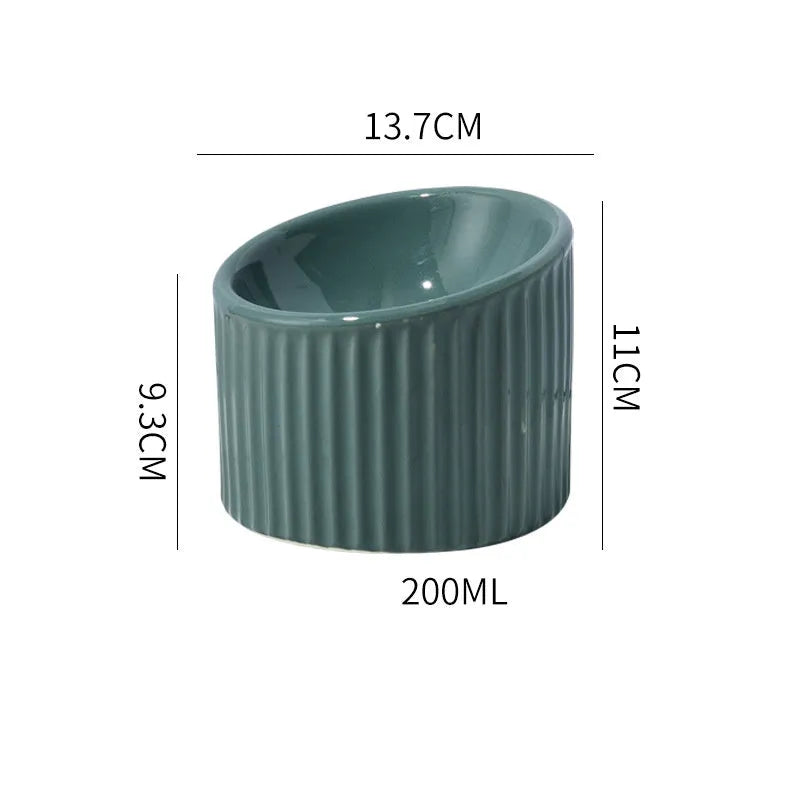 Ceramic elevated cat bowl in green colour, showing tilted design and raised feeding height.