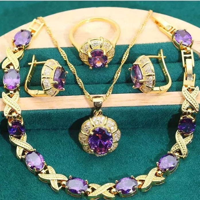 Gold plated women's jewellery set with necklace, earrings, ring, and bracelet featuring coloured zircon stones.