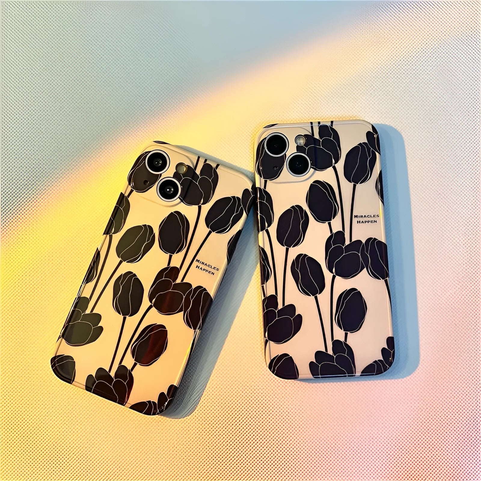 Black silicone iPhone case with tulip flower design shown on mobile phone