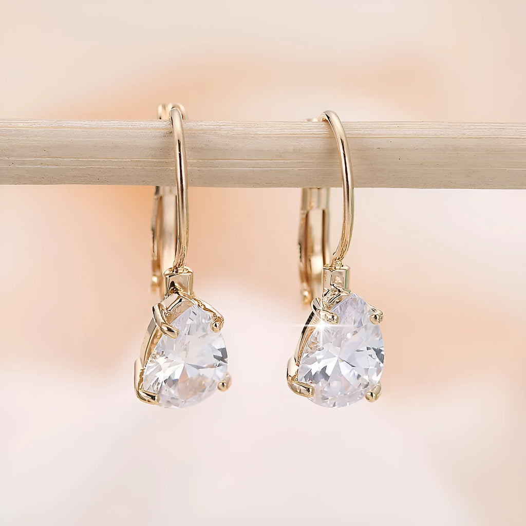Women's drop-shaped copper earrings with a gemstone inlay, available in gold or platinum colour finish.