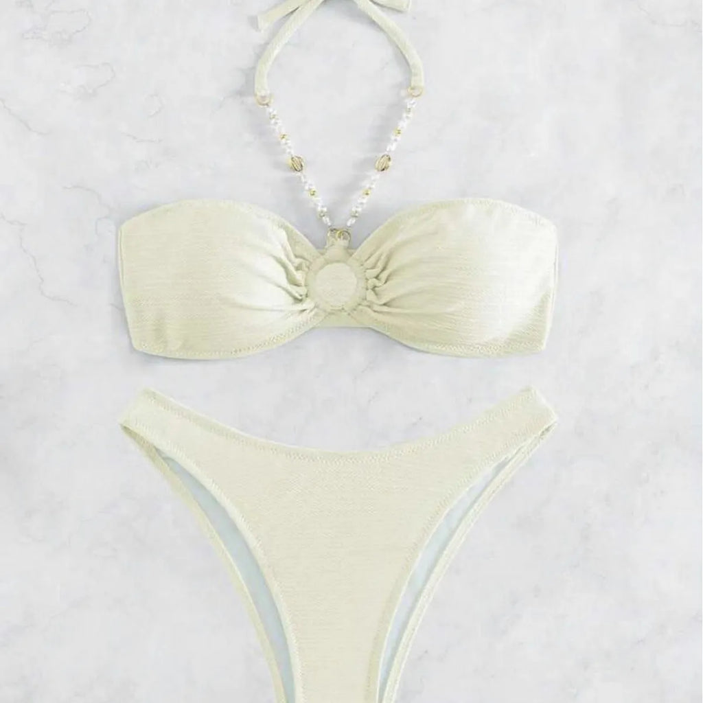 Women's halter-style bikini set in solid colour on a white background.