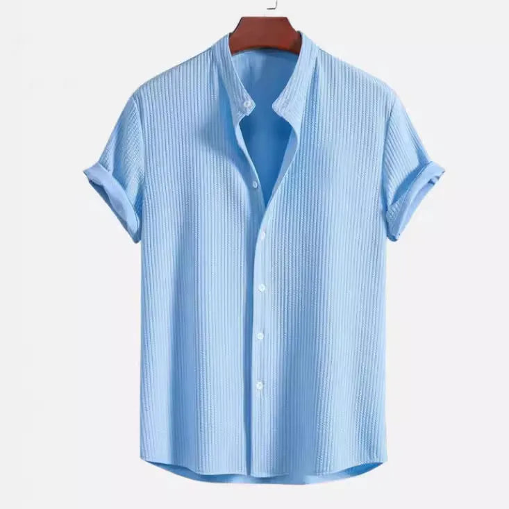Man wearing a loose-fitting short sleeve polyester shirt in light blue, showcasing the casual summer style.