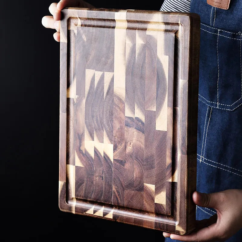 Brown solid acacia wood cutting board with 3cm thickness on a kitchen counter.