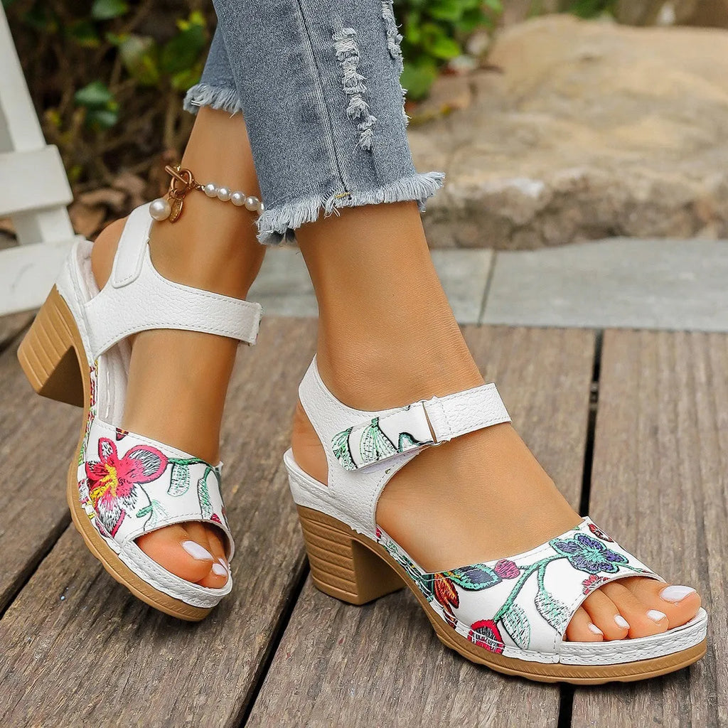 White women's high heel sandals with a Velcro strap fastener on a casual rubber sole.