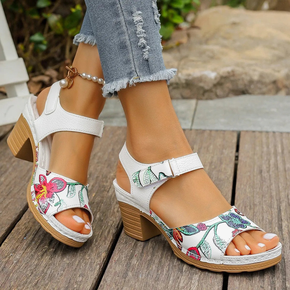 White women's high heel sandals with a Velcro strap fastener on a casual rubber sole.