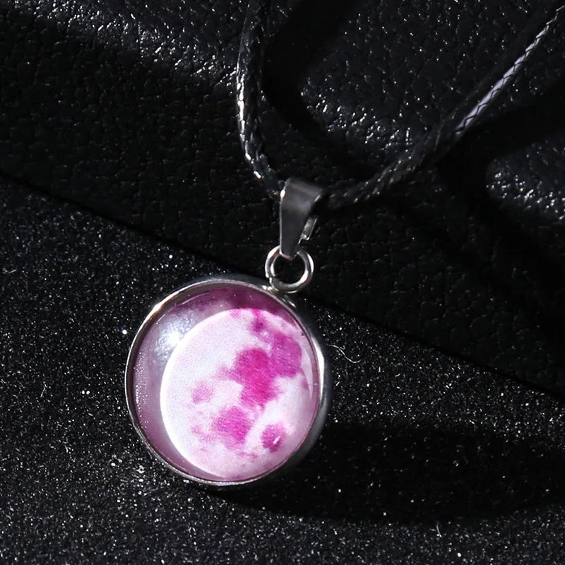 Luminous moon and constellation pendant necklace on a chain with an extension, shown in one of ten possible colours.