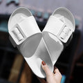Women's grey blue flip flop slippers with a silver buckle on the strap and a textured EVA sole.