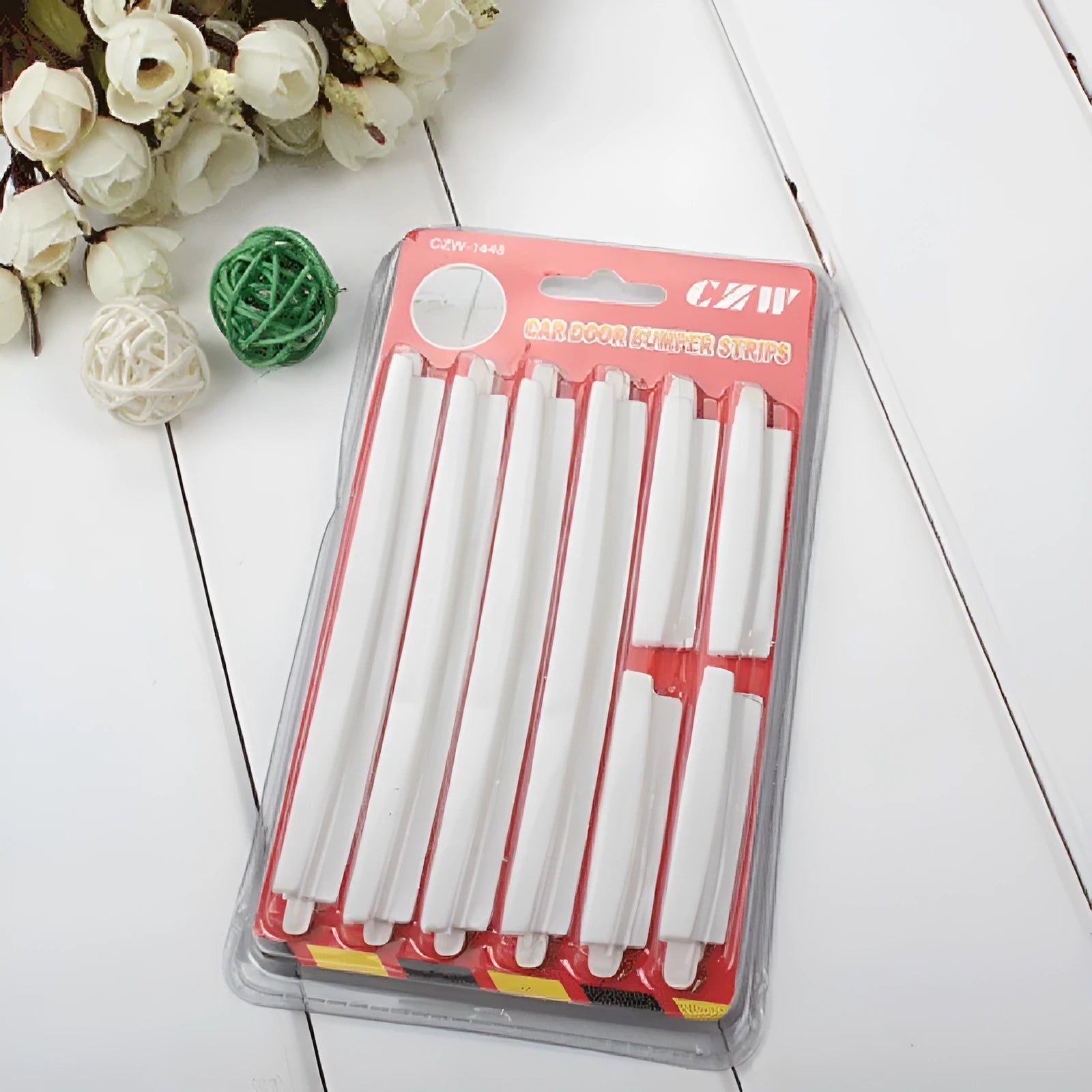 White plastic car door edge protection bumper strip set on a clean background