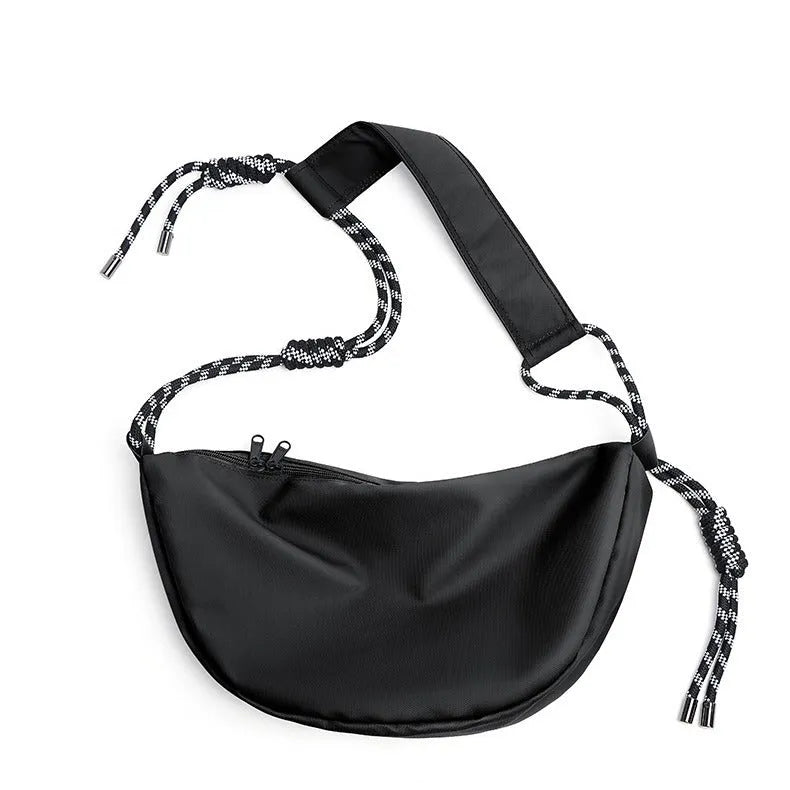 Men's nylon messenger backpack in black colour showing large capacity interior and lightweight construction