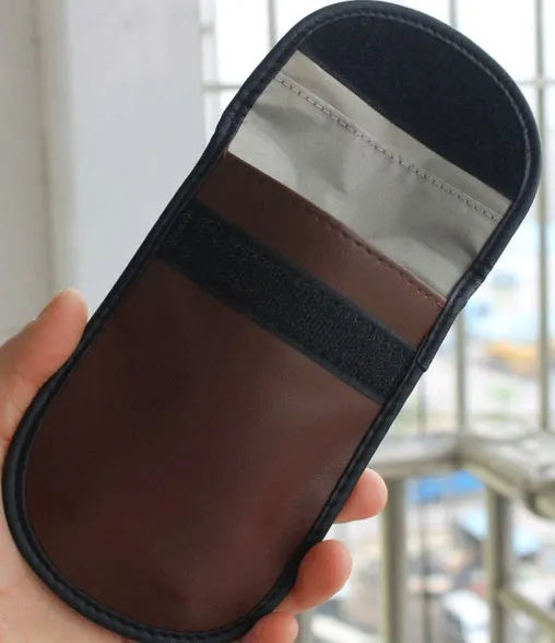 Black microfiber Faraday cage bag for blocking key fob and card signals, shown with dimensions 13.5cm by 9.5cm.