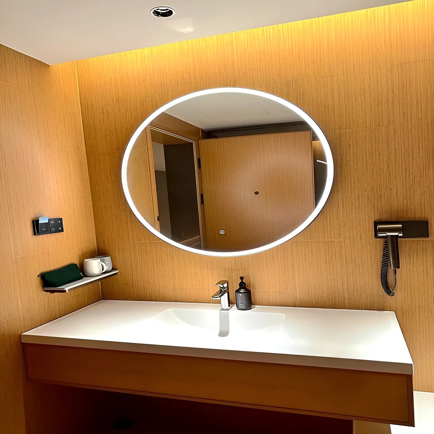 Round black aluminium alloy smart LED makeup mirror mounted on a wall with dimmable lighting.