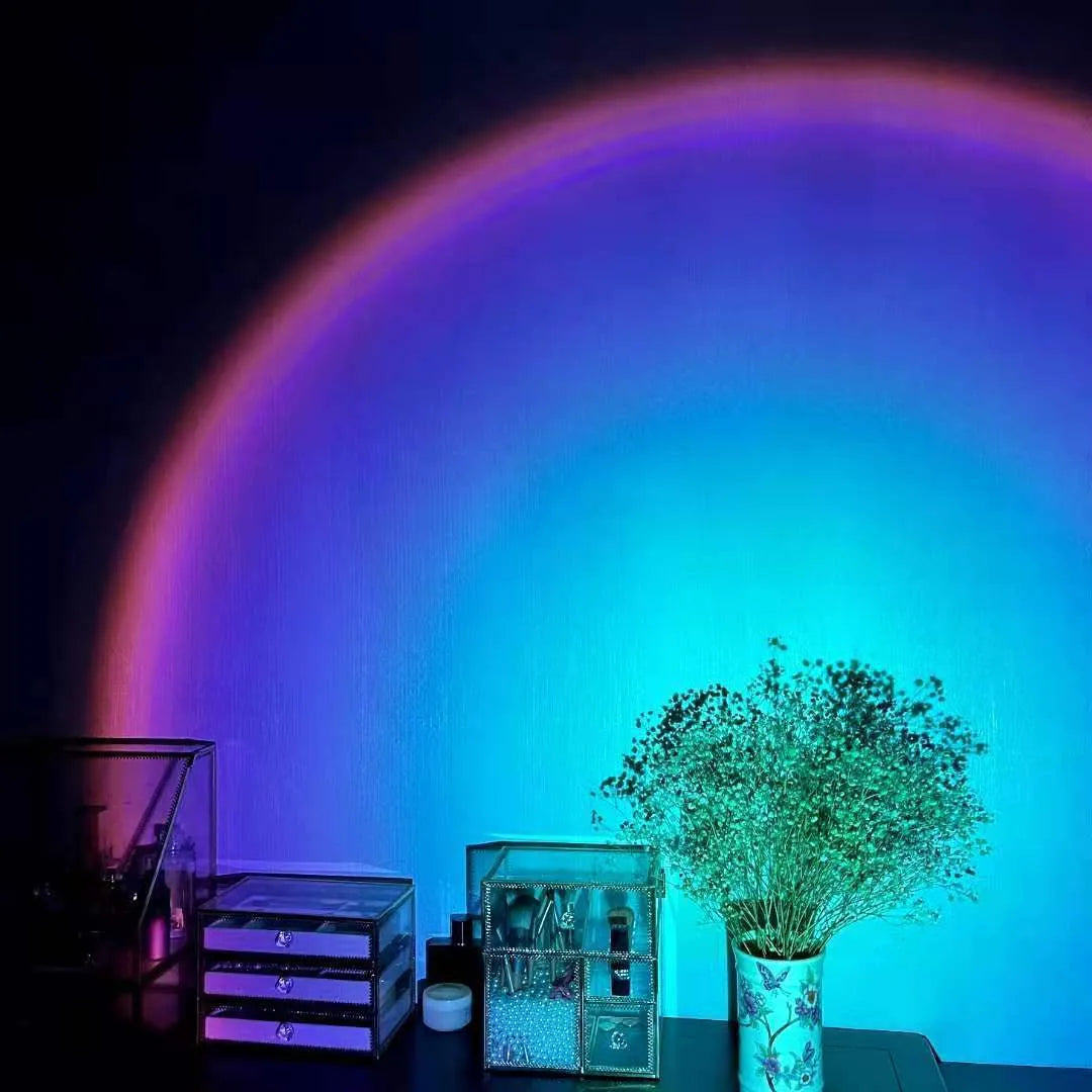 Rechargeable sunset projection lamp showing rainbow colour effects with USB cable