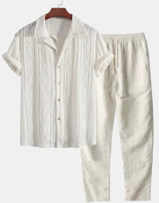 Man wearing a loose fit short sleeve shirt and matching trousers in a light colour, a summer casual suit.