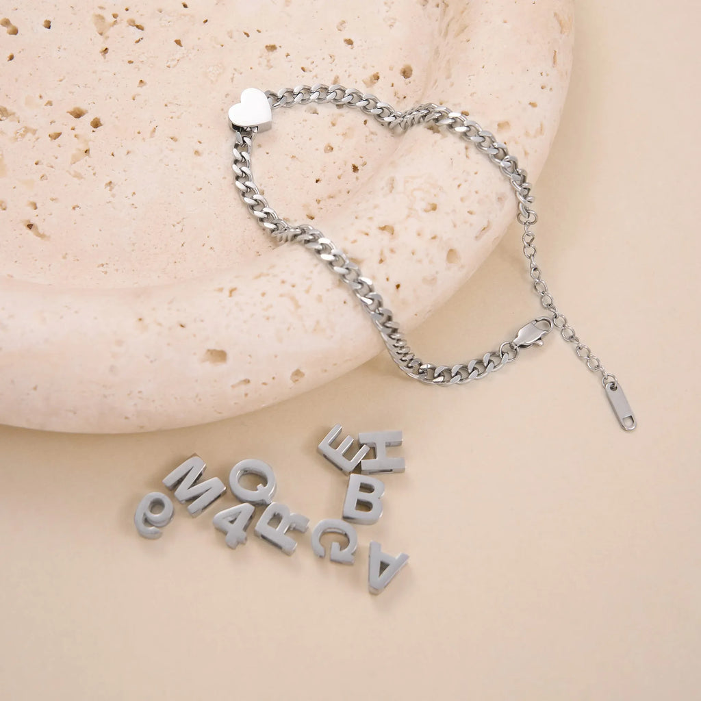Gold and silver titanium steel personalised necklace showing number and letter pendant options on 40.5cm chain
