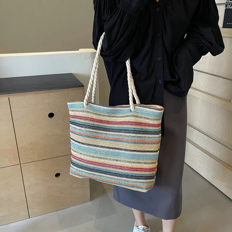 Blue straw woven nylon shoulder bag with a large capacity and polyester lining.