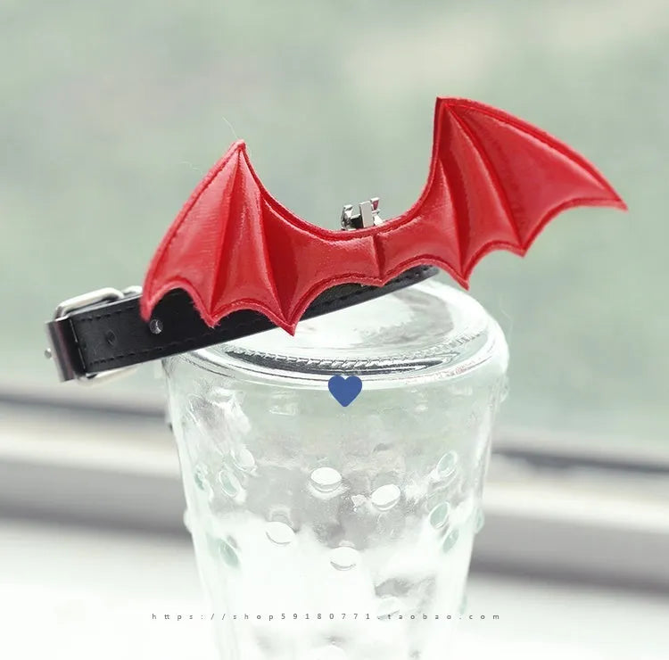 Black patent leather choker collar with devil wings design and bell attachment