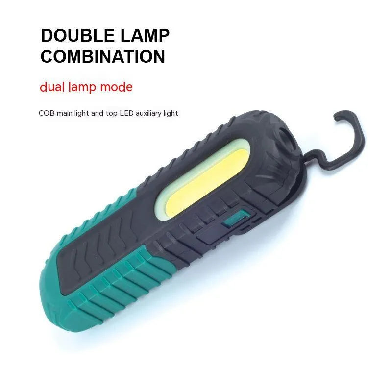 Black and green auto repair work light with USB charging cable for vehicle maintenance