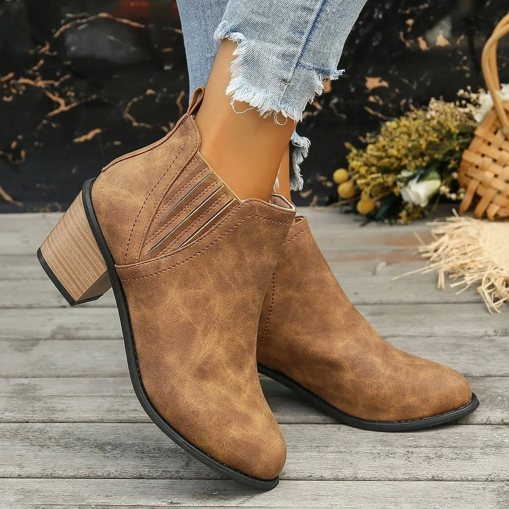 Women's black ankle boots with pointed toes and thick square low heels, slip-on design