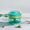 Green manual baby food grinder with 300ml capacity container and stainless steel blade