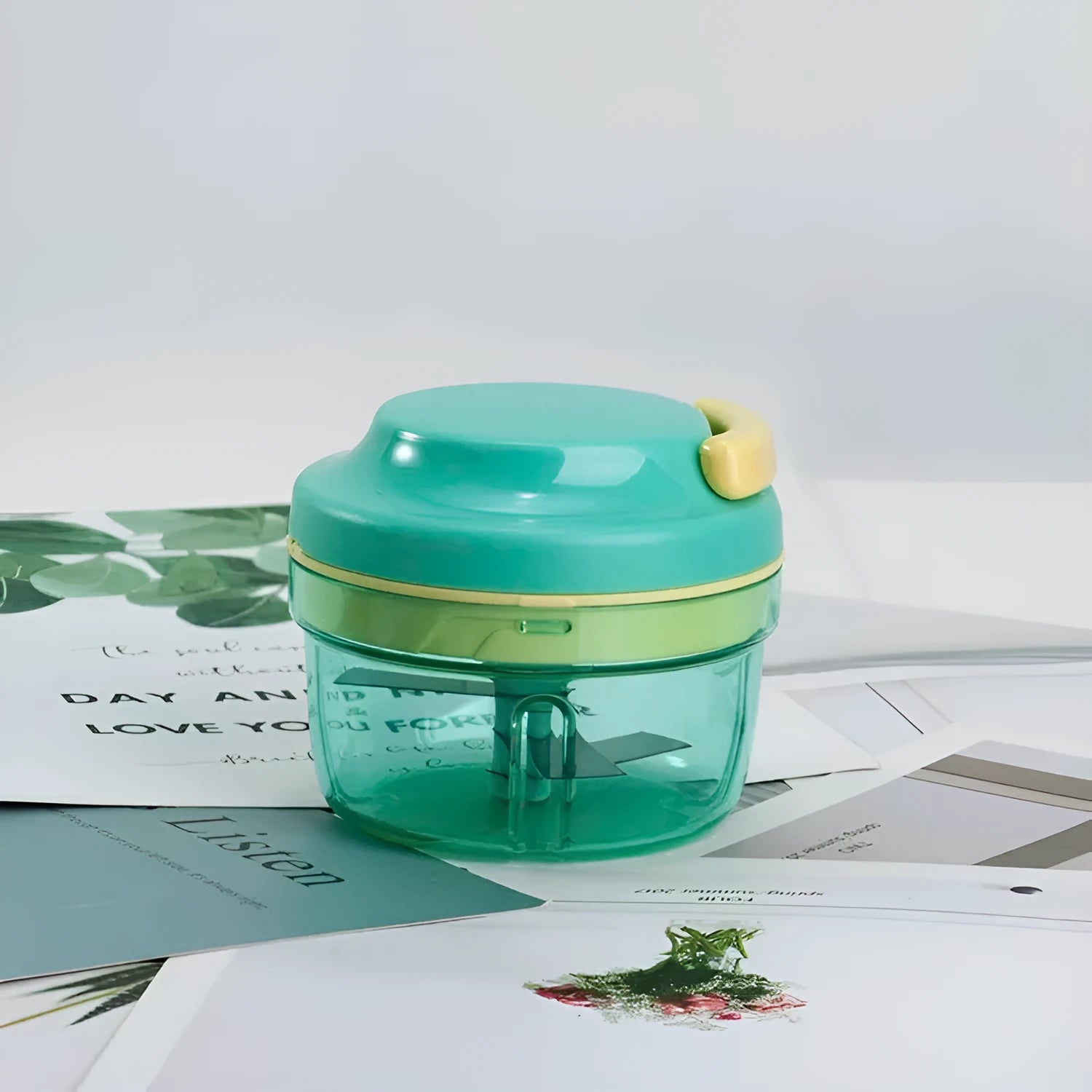 Green manual baby food grinder with 300ml capacity container and stainless steel blade