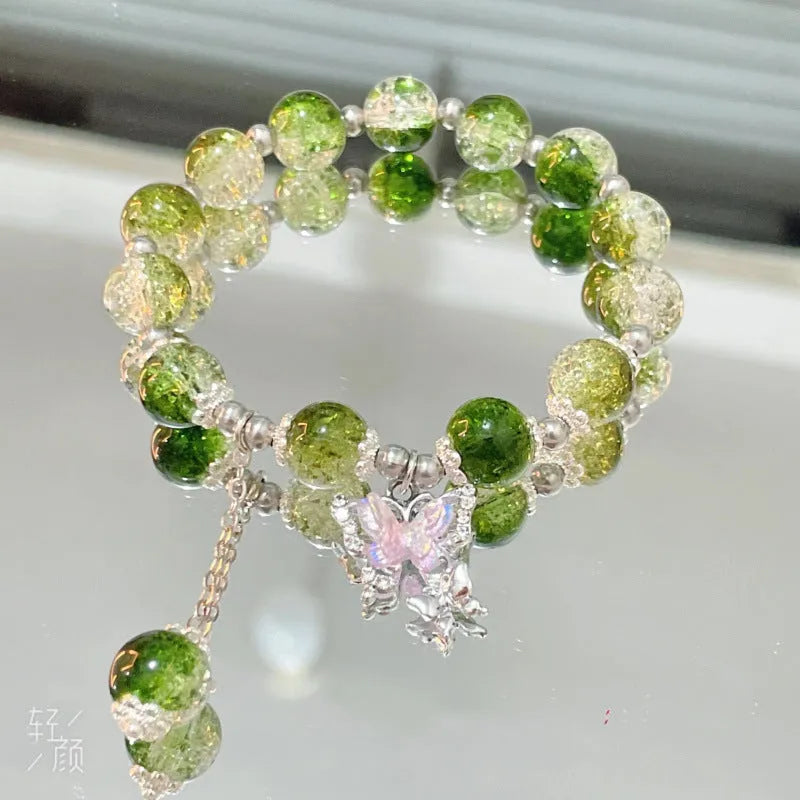 Chinese style handmade glass bead bracelet with bamboo joint elements on a white background.