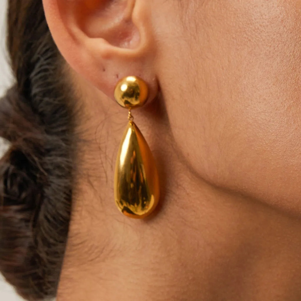Gold-coloured stainless steel earrings with hemisphere and water drop pendant design