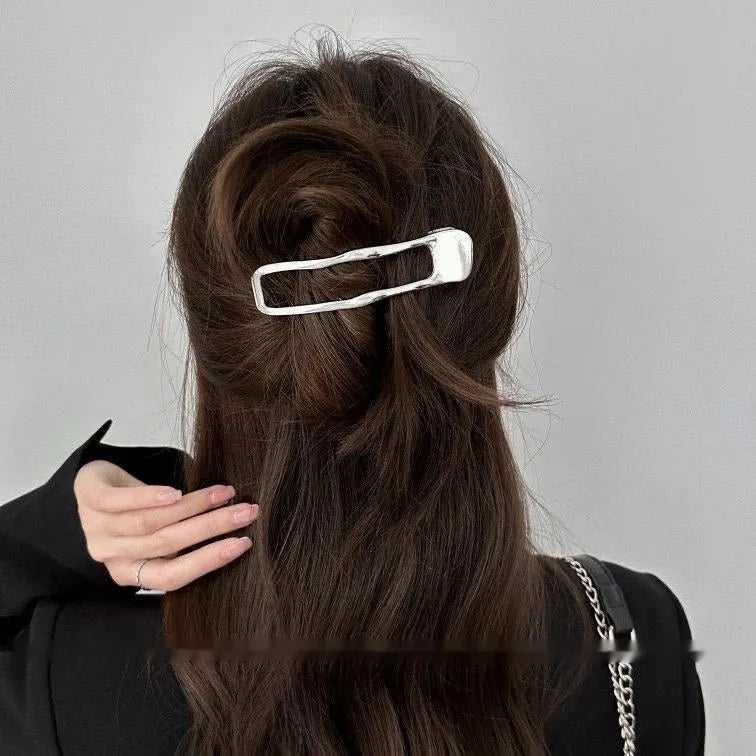 Women's zinc alloy hair barrette in gold and silver, showing square, arc and triangle shapes.