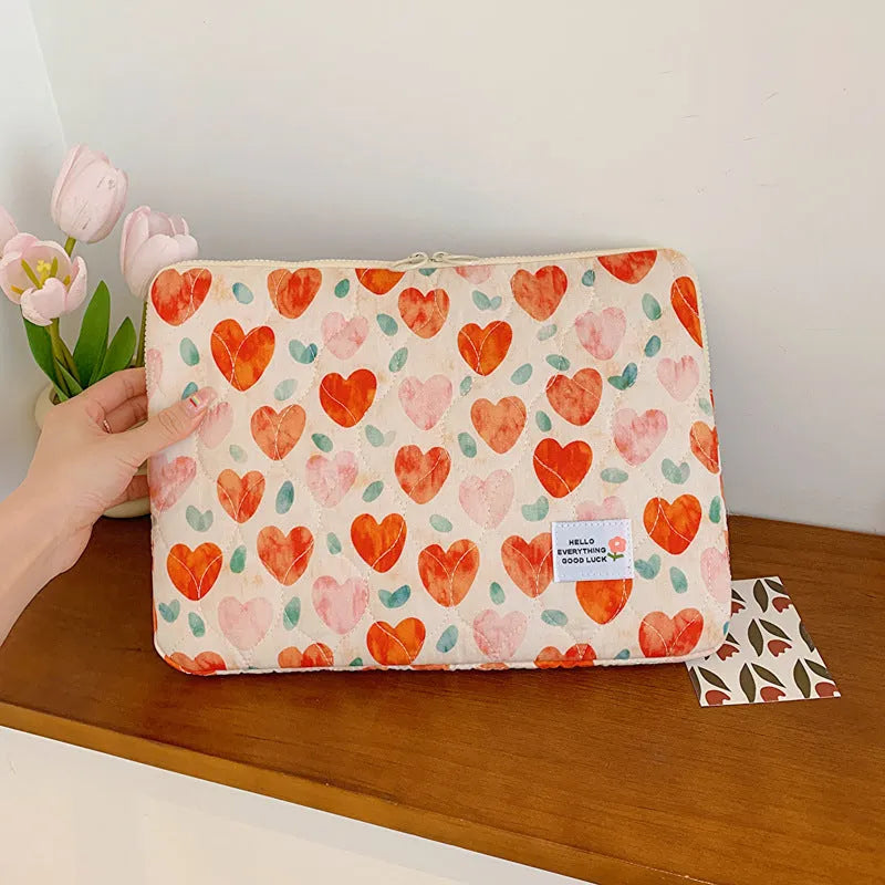 Women's floral print cloth laptop bag showing green flower pattern, available in small, medium, and large sizes.