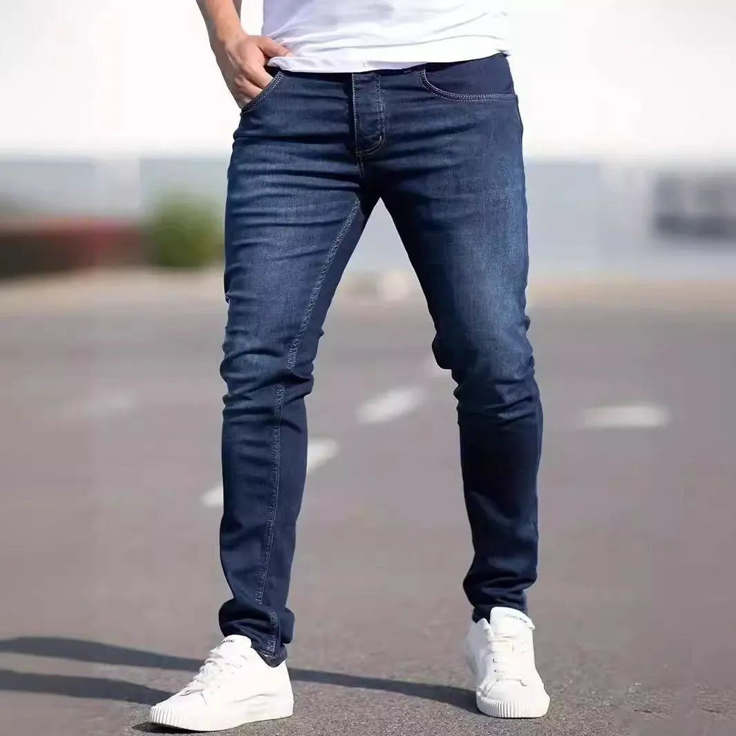 Men's dark blue slim-fit casual jeans with skinny leg and zip fly.