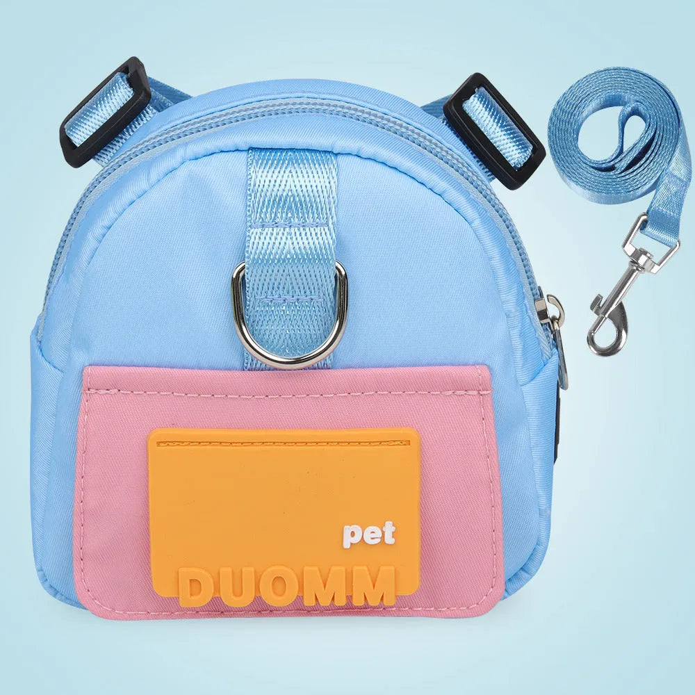 Blue adjustable dog backpack harness with storage compartments and a tow rope attached.