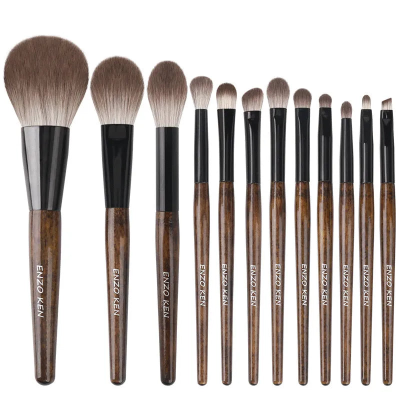 12-piece makeup brush set with wooden handles and a grey PU case