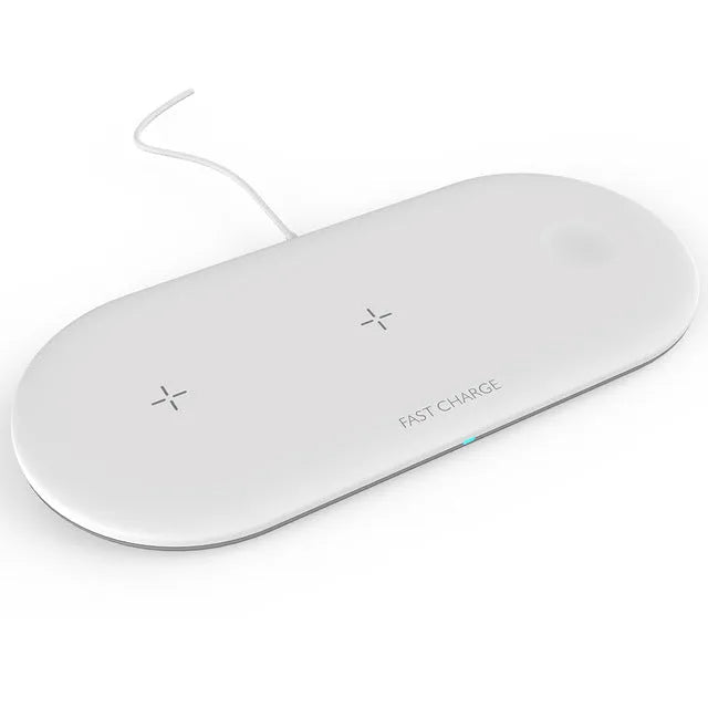 Black and white three-in-one wireless charging station for iPhone, Apple Watch and headphones on a desk.