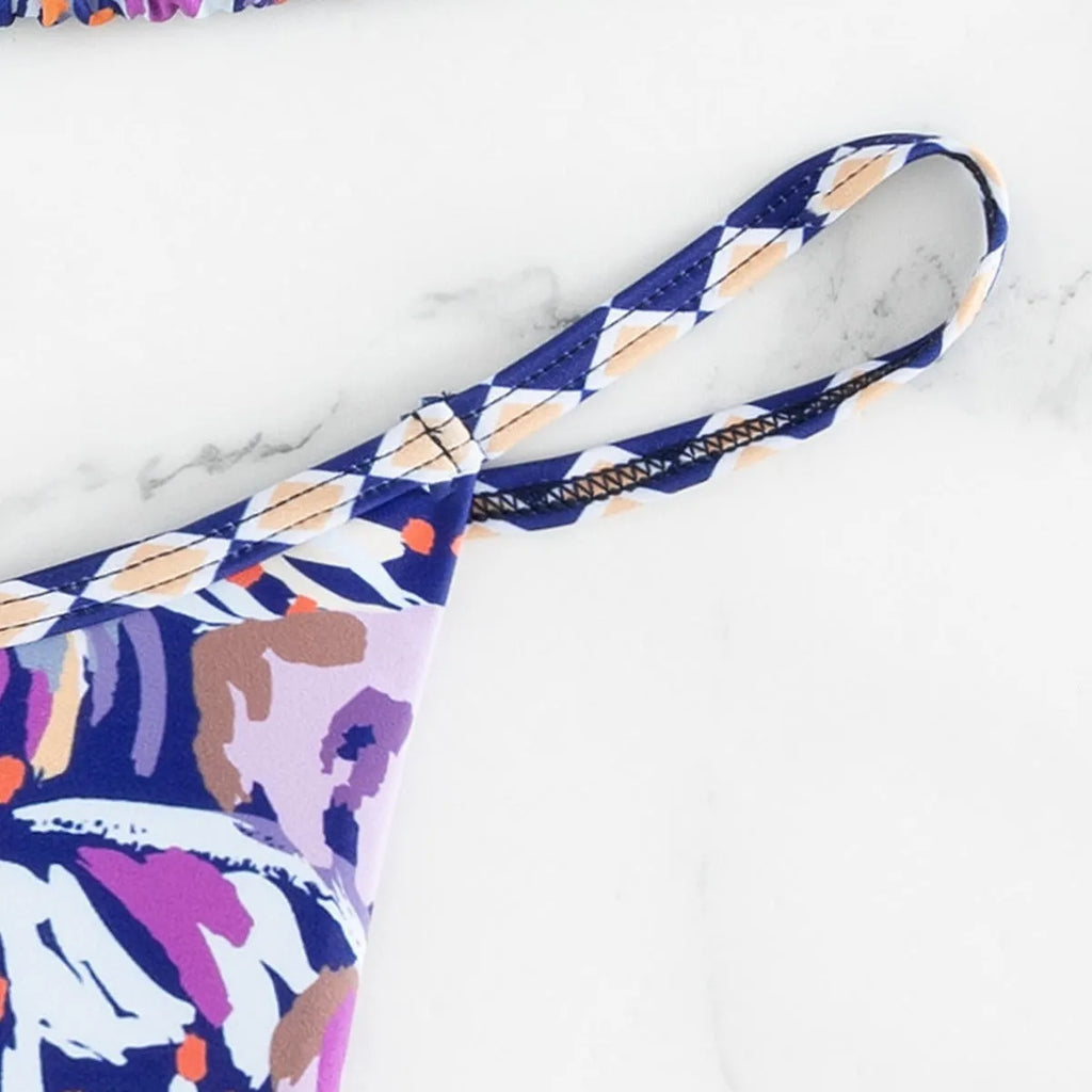 Women's floral print polyester swimsuit briefs on a white background.