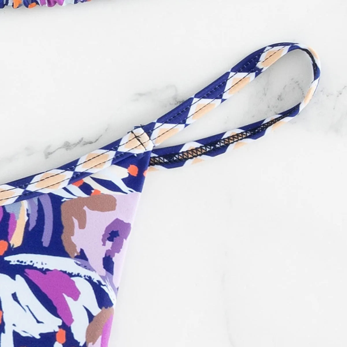 Women's floral print polyester swimsuit briefs on a white background.