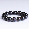 Polished crystal Pi Xiu bracelet on wrist, showing ethnic geometric style and Icy Obsidian colour.