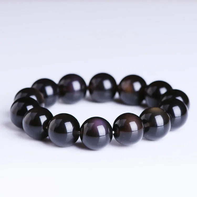 Polished crystal Pi Xiu bracelet on wrist, showing ethnic geometric style and Icy Obsidian colour.