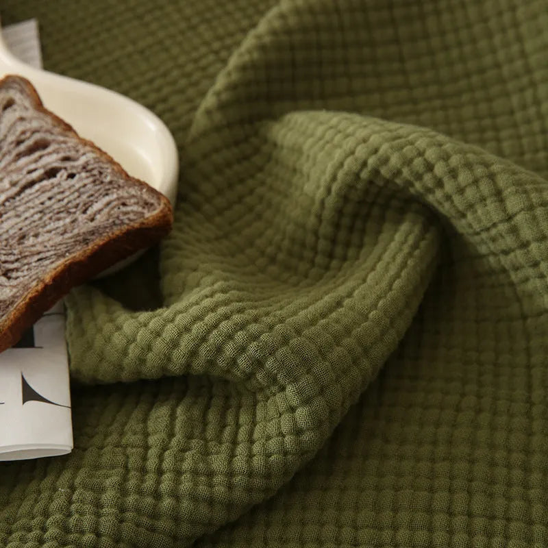 Four-layer cotton gauze blanket with tassel trim in avocado green colour