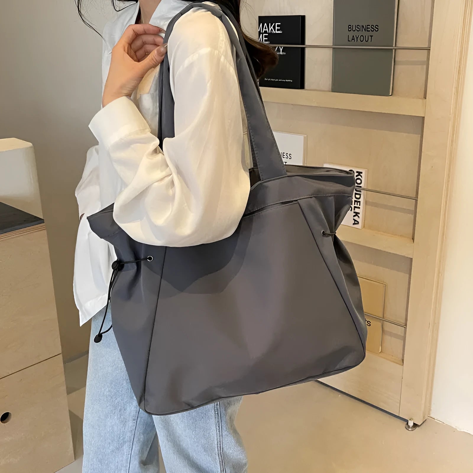 Soft Oxford cloth foldable tote bag shown in one of five colours: black, brown, dark grey, light grey, or purple.